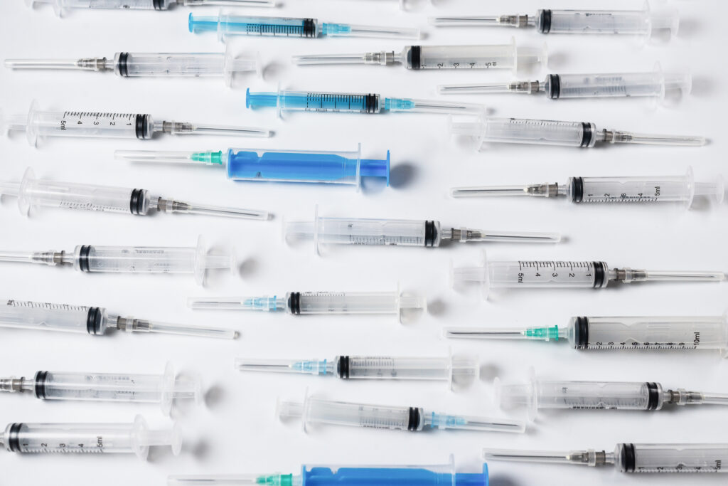 Many medical syringes as a background.